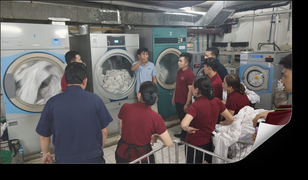On-floor laundry training session with Inthichack instructor and hotel staff