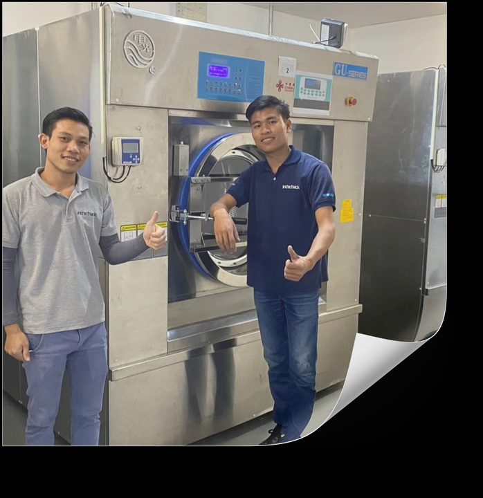 Inthichack engineers in front of a commissioned industrial washer