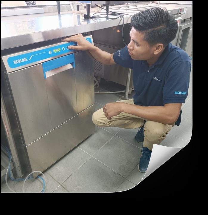 Inthichack service technician on-site at a commercial dishwasher